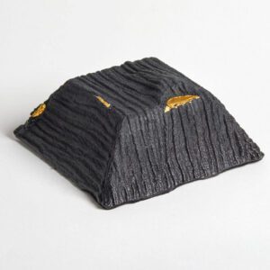 Handmade Glass Sculpture. Black glass fired with gold. Textured. Cut off pyramid form.