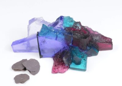 Handmade glass sculpture in the form of a fallen wall in clear, aqua, red and lilac