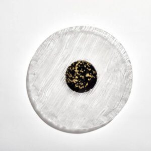 Glass cake plate with black and gold base.