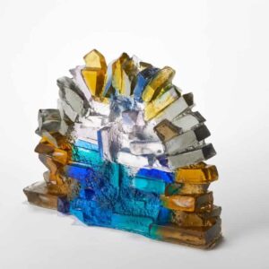 Vibrant glass art piece featuring blue, yellow, and clear glass elements, showcasing craftsmanship a.