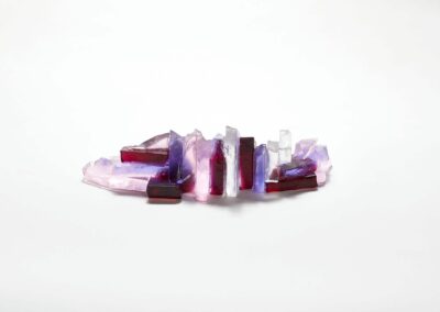 Rocky outcrop under a pink sunset glass sculpture by Deborah Timperley.