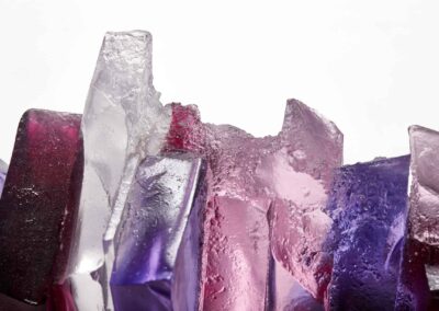 Rocky outcrop under a pink sunset glass sculpture by Deborah Timperley.