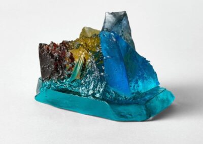 Colourful glass art sculpture with blue, yellow, and black hues.