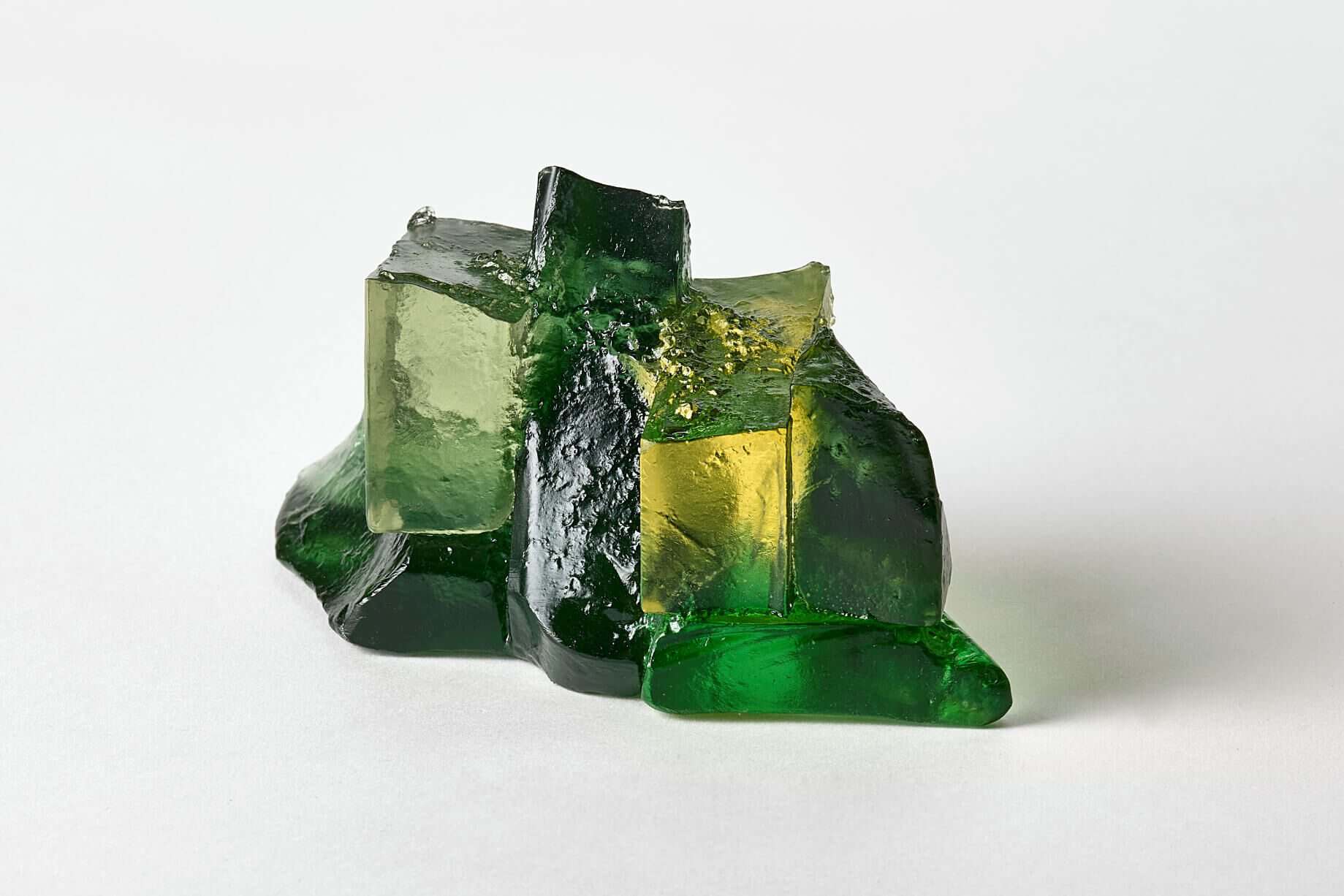 Glass art sculpture with green and yellow hues, showcasing Deborah Timperley's unique glasswork craf.