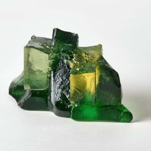 Glass art sculpture with green and yellow hues, showcasing Deborah Timperley's unique glasswork craf.