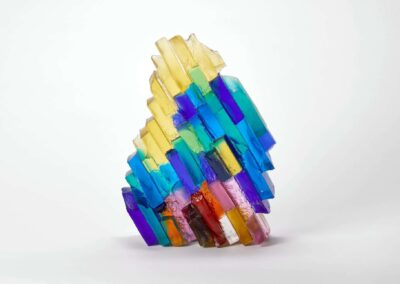 Vibrant glass art sculpture with colourful, layered glass pieces arranged in an abstract design.