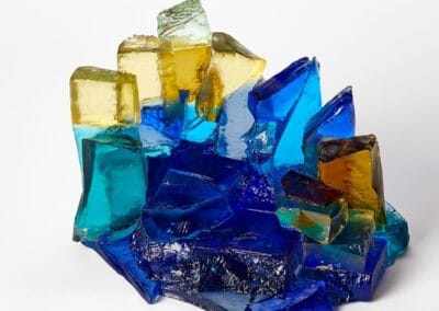 Vibrant glass art piece showcasing blue, yellow, and green hues with intricate textures.