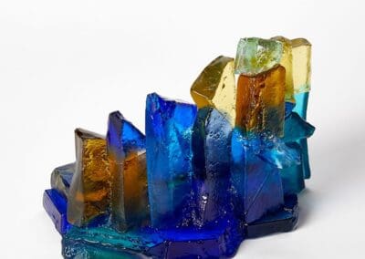 Vibrant glass art sculpture featuring colourful geometric shapes and textures.