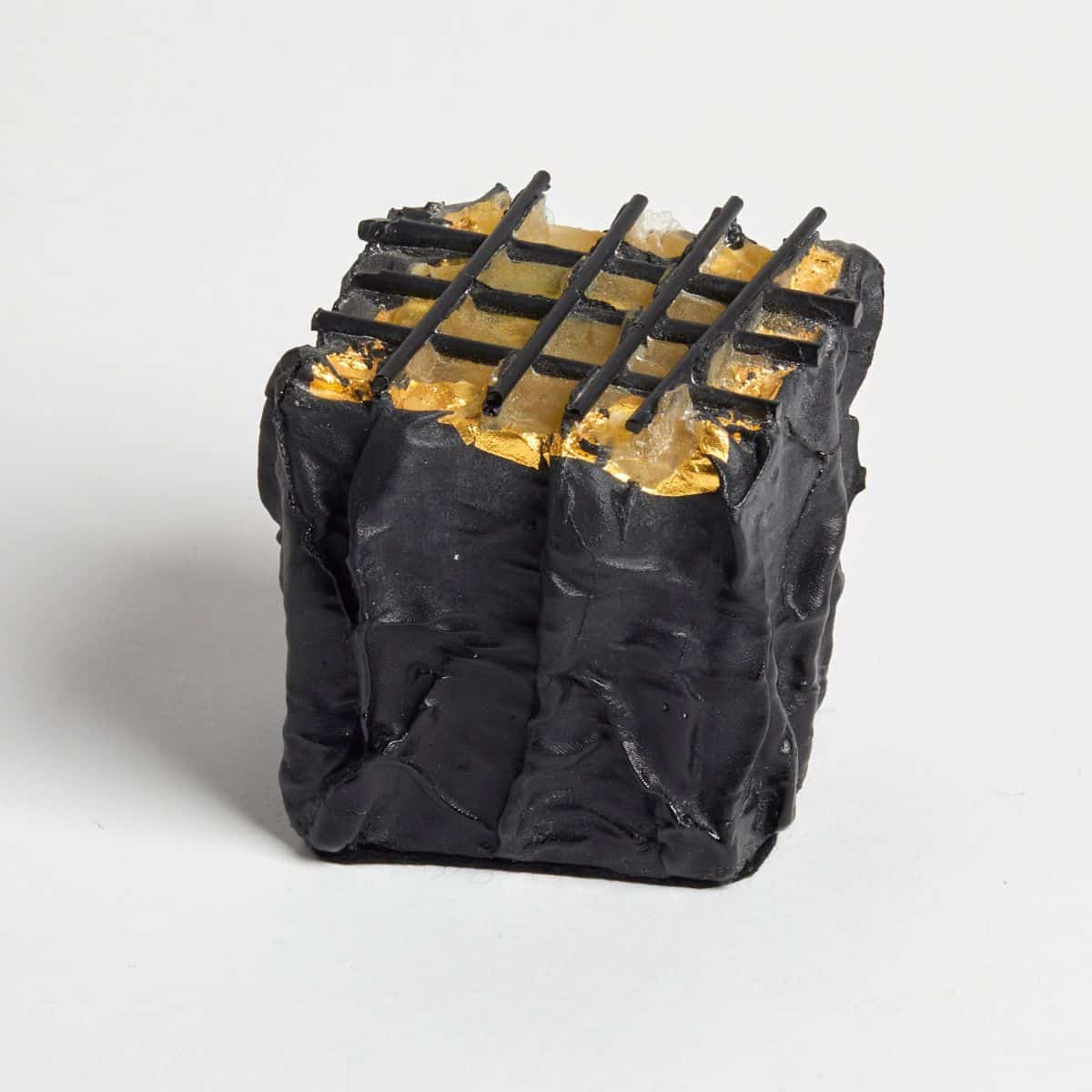 Elegant black and gold glass csulpture with geometric pattern, perfect for contemporary interior decor.