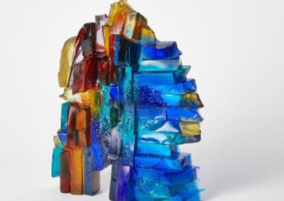Colourful glass art sculpture with abstract geometric shapes and vivid hues.