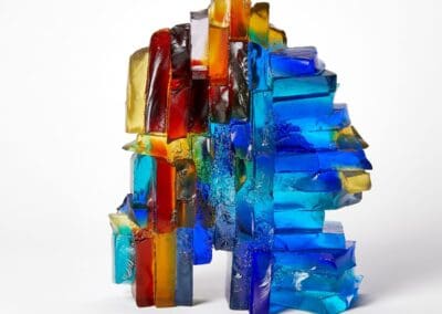Colourful glass sculpture with geometric shapes, vibrant hues, and artistic design.