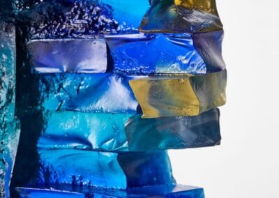 Vibrant blue and yellow glass sculpture by Deborah Timperley, showcasing colourful glass art.