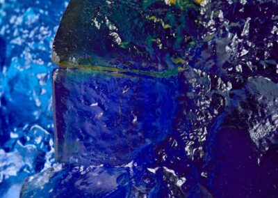 Rocky outcrop in blue, yellow and amber. Landscape glass sculpture by Deborah Timperley.