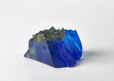 Rocky outcrop in blue, yellow and amber. Landscape glass sculpture by Deborah Timperley.