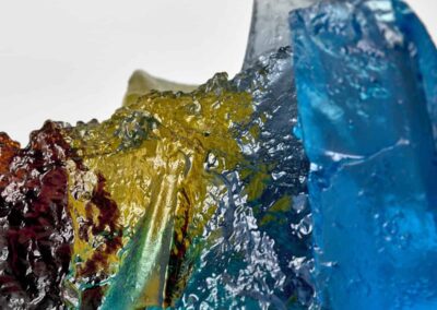 Rocky outcrop in blue, yellow and amber. Landscape glass sculpture by Deborah Timperley.