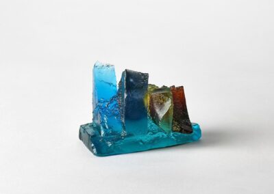 Rocky outcrop in blue, yellow and amber. Landscape glass sculpture by Deborah Timperley.